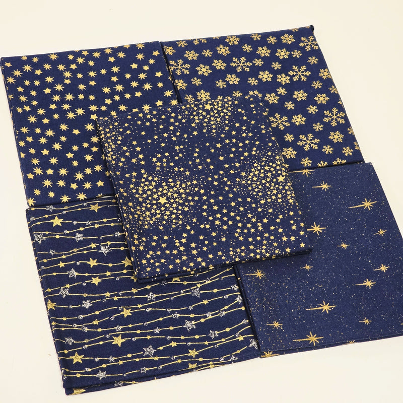Set of blue fabric swatches with gold star patterns on a beige background