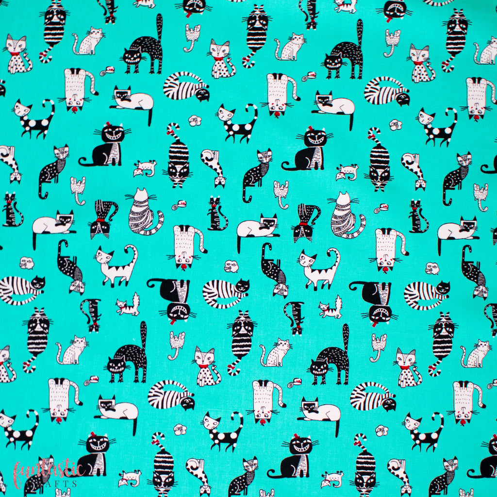 sassy cats on teal cotton fabric