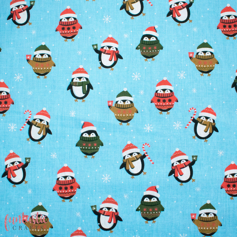 Penguins in Christmas Jumpers on Blue Polycotton Fabric