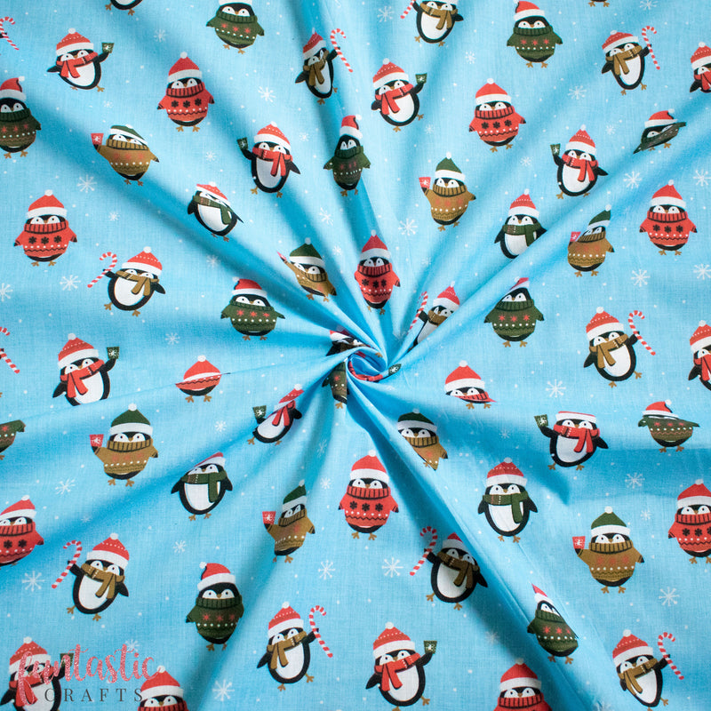 Penguins in Christmas Jumpers on Blue Polycotton Fabric